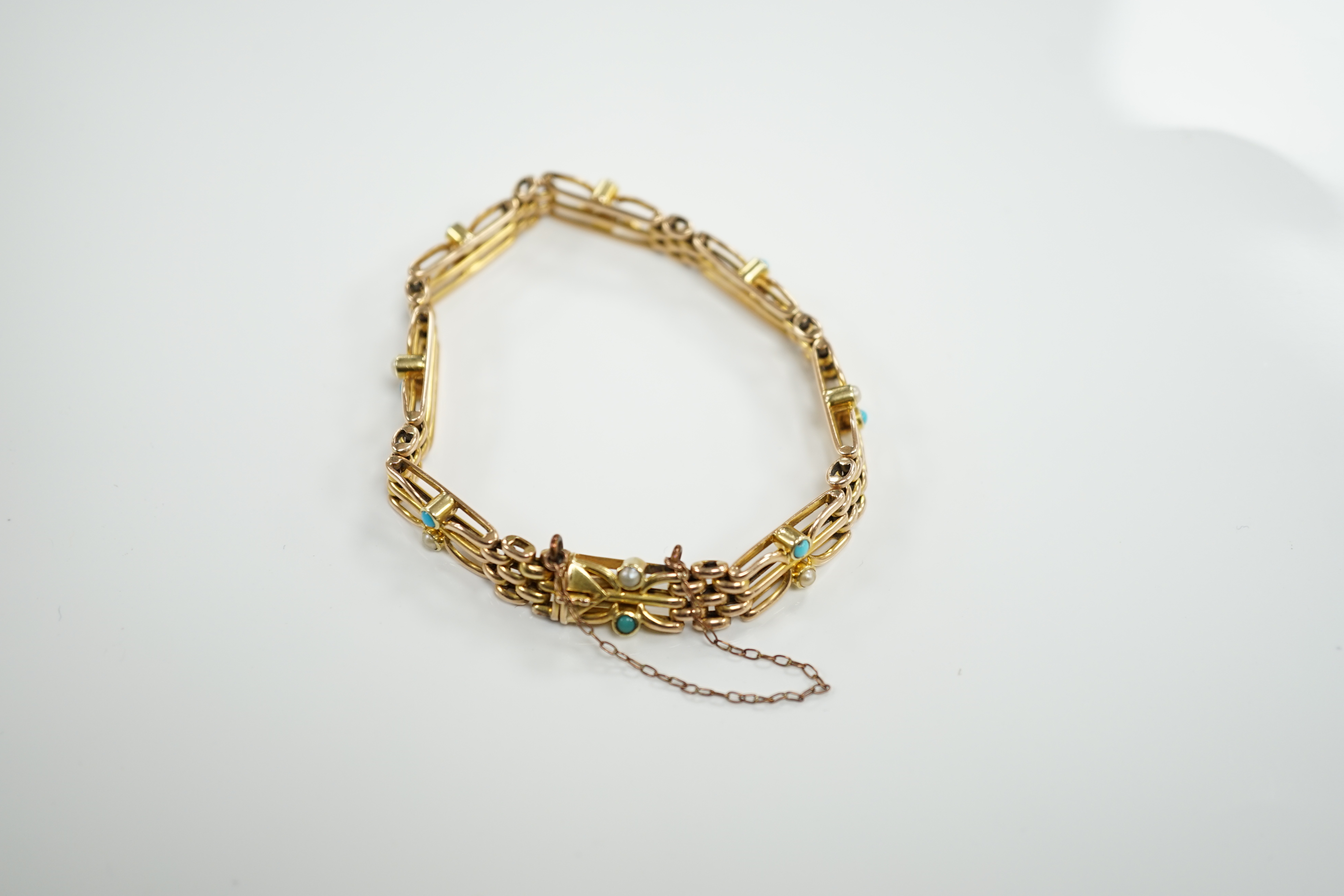 An Edwardian 15ct, turquoise and seed pearl set gate link bracelet, 18cm, gross weight 16.7 grams.